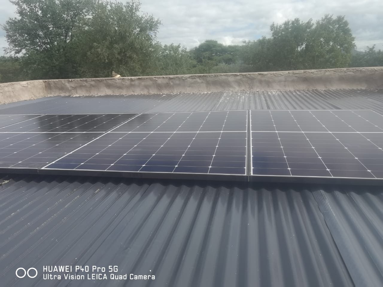 Solar panels mounted on a low-pitch farm roof